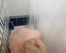 Mother-in-law takes a shower and washes her big tits